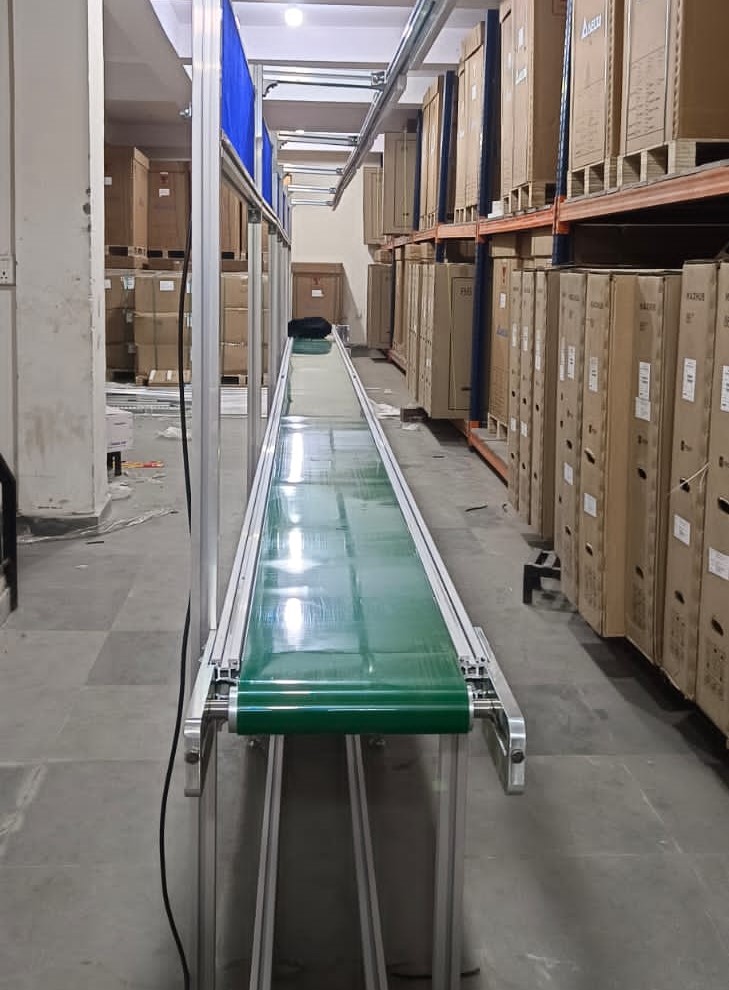 Overview of the custom-designed 10-meter Belt Conveyor system installed by Warehouse International Pvt. Ltd. for Temflow India Private Limited in Delhi Sahibabad.